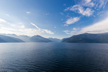 Amazing sunset views of the Sognefjord in Norway during a amazing Summer evening seen from the backside of a ship, when cruising through the unique natural landscape of Norway and its fjords, while th
