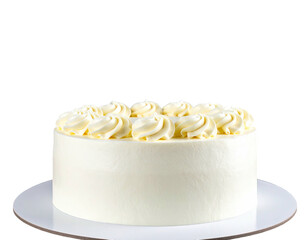 Creamy, round cake on a white surface, adorned with swirls, against black