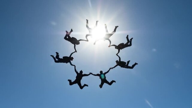 Skydiving group forms human shape above clouds