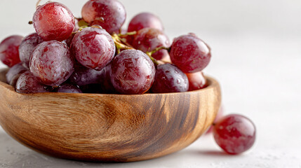 Fresh red grapes in a wooden bowl, healthy snack, vibrant still life, close-up studio shot
