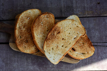 White bread toasted on an outdoor Grill on wooden table