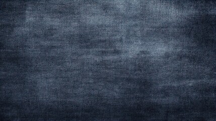 A detailed close-up of dark blue denim fabric texture, showcasing its classic woven pattern and slightly worn, rugged surface. Ideal for backgrounds or design elements, blurred blue background