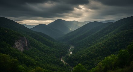 Obraz premium Dramatic mountain landscape with overcast sky and flowing river nature photography
