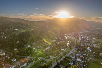 Aerial sunset view of Silesian Beskids mountain town and valley, southern Poland