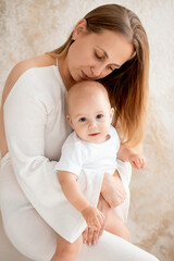 mother and baby hugging and kissing at home, mother's love and care, mother and child, mother playing with a small child