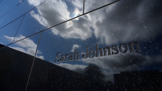 Reflection of sarah johnson logo on glass surface