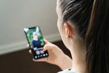 Date app scam and online romance fraud. Woman looking man's profile in phone screen. Single or...