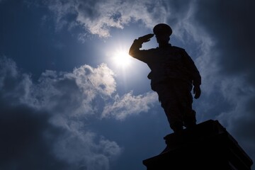 Silhouette of a military statue saluting, backlit by a bright sun against a dramatic, cloudy sky, symbolizing honor and remembrance.