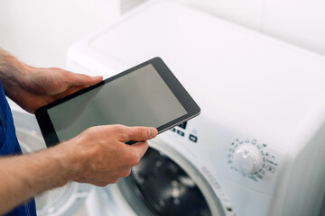 Repairing a washing machine with a modern tablet at home