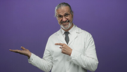 Man scientist with hoary long hair in white lab coat holding out palm against purple studio wall; curiosity research insight.