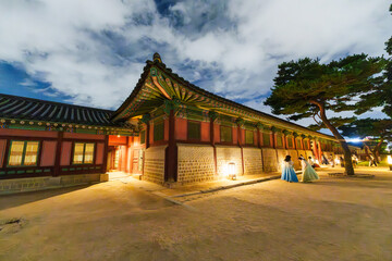 Gyeongbokgung Palace at night in South Korea, with the name of the palace 'Gyeongbokgung' on a sign, 