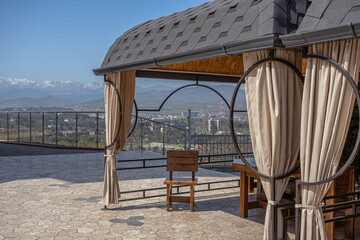 Wooden furniture in the gazebo. The gazebo has chairs and a table made of natural wood. It is a place for relaxation and relaxation. Furniture for outdoor cafes.
