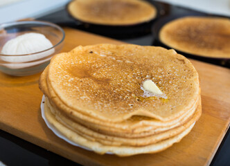 cooking traditional pancakes from wheat flour in the kitchen