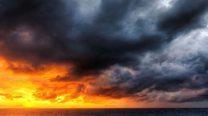 Dramatic sunset over the ocean with dark clouds, creating a striking contrast and moody atmosphere
