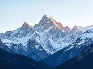 Fototapeta premium Majestic snow capped mountain peak against a clear sky, dramatic landscape, pristine nature, vast wilderness, outdoor adventure, high altitude vista.