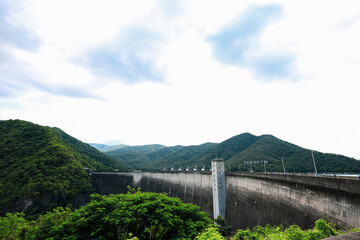 Landscape of Bhumibol Dam, Thailand, beautiful scenery amidst the nature of river near large dam. Renewable hydropower plants for electricity.