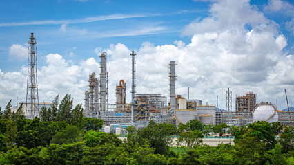 Landscape view of a large oil and chemical refinery against a blue sky, showcasing innovative engineering,