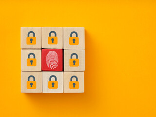 Fingerprint replacing lock on wooden blocks illustrating cybersecurity concept