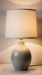 Modern ceramic table lamp glowing with cozy, warm light.