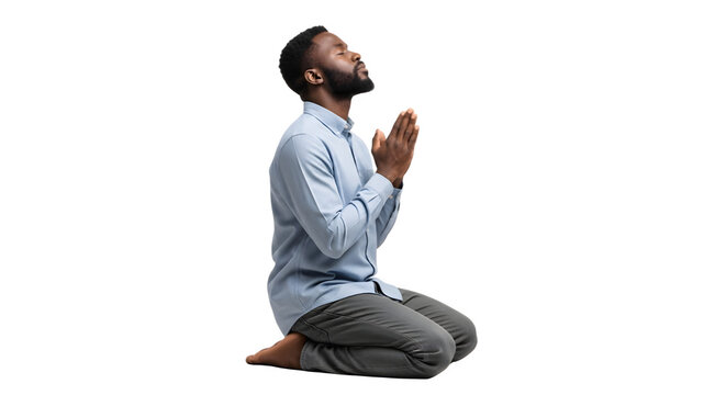 Devout young man with a beard kneeling in prayer.