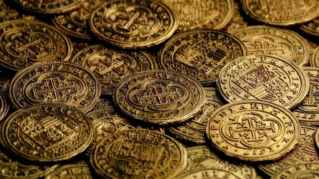 Gold Bullions with gold coins English pound coins fall onto pile of coins Dolly shot over various coins background with gold of coins