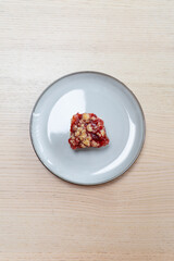 A slice of strawberry rhubarb cake with oat crunch.