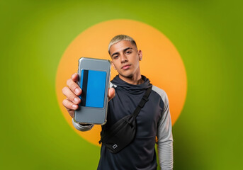 Modern young man holding phone with credit card, showcasing mobile payments and secure digital banking for a seamless, on-the-go lifestyle
