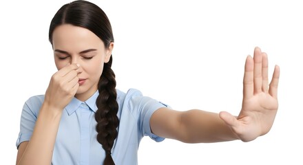 Woman holding her nose and making a stop gesture expressing disgust from the bad smell isolated on white backdrop for sensitive content