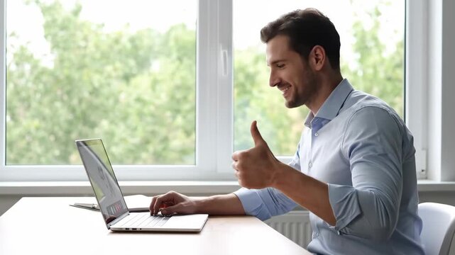 Happy businessman at office desk works on laptop shows thumbs up for success this smiling professional is satisfied with his great work this is a good business result