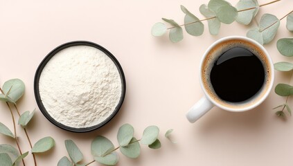 A light, airy powder sits beside a rich cup of coffee, surrounded by soft eucalyptus sprigs, in a minimalist arrangement.