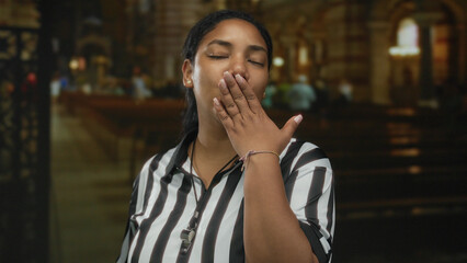 Fototapeta premium Woman referee in striped jersey blows kiss indoors at ornate church interior with visible whistle; love.