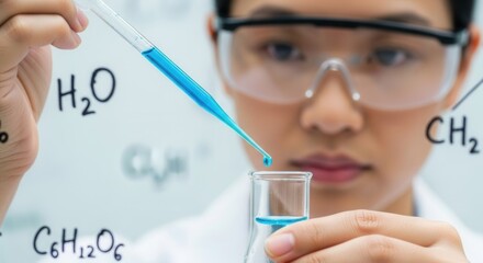 A person in safety goggles and a lab coat conducts a chemical experiment adding blue liquid from a pipette into a flask with chemical formulas in the background