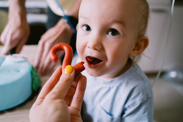 Birthday cake! Little boy celebrates his second birthday at home with his family. The children...