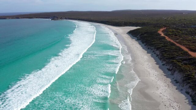 Aerial drone view of waves breaking along the coast of Vivonne Bay, Kangaroo Island, South Australia