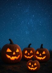 Glowing pumpkins under starry sky.