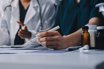Medical team meeting analyzing blood test results in hospital laboratory. Doctors and scientists in...