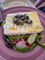 Fresh Greek salad with capers on top