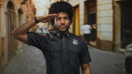 Police officer performs a salute on a city street, capturing focus with confident posture against a...