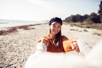 Happy woman holding hands on the beach