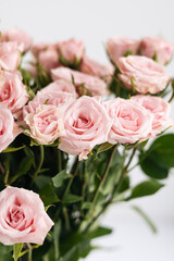 Close-up, bouquet of small pink roses on a white background.