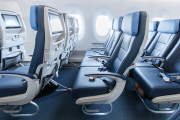 Fototapeta premium Blue economy class seats inside a widebody aircraft at Viracopos Airport, Brazil, on September 16, 2022.