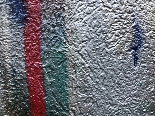 Shiny metallic silver green, red, black  street-art paint graffiti close-up rough texture wallpaper background