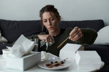 Struggling with sadness at home, a young woman finds solace in takeout and reflection