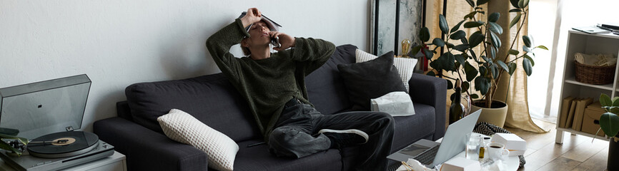 Obraz premium Young woman struggling with emotions in a cozy home environment during a quiet moment