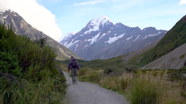 A Man walking the Hooker Valley Track in the Mt Cook Aoraki Mount Cook National Park, New Zealand. This is a popular hiking trail in New Zealands South Island.