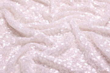 Close-up of shimmering white bridal spangle fabric with sequins creating a sparkling texture, perfect for fashion, textiles, bridal and luxury design backgrounds.