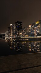 Lake Mälaren with reflections in the water at night overlooking the architecture and lights of Stockholm City, Sweden
