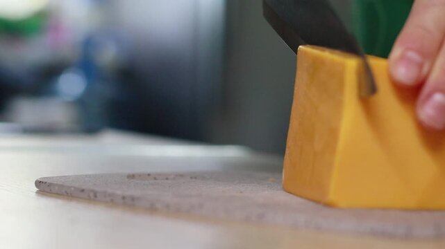 Close-up footage of hands slicing cheddar cheese, placing it on a slice of bread, and adding fresh cherry tomatoes on a plate. Perfect for food blogs, cooking tutorials, recipe videos