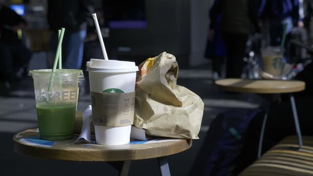 Abandoned Fast Food Rubbish on Table at King&rsquo;s Cross Station.
A close-up shot of discarded takeaway drinks and food packaging left on a caf&eacute; table inside King&rsquo;s Cross Station, London. 