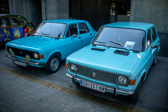 Two light blue classic Zastava 101 (FIAT 128, Stojadin, Skala, Yugo) cars parked side-by-side. Yugoslavian automotive history, nostalgia and timeless retro design. 08 June 2025 Subotica, Serbia